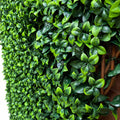 Close-up of artificial laurel leaves on willow trellis